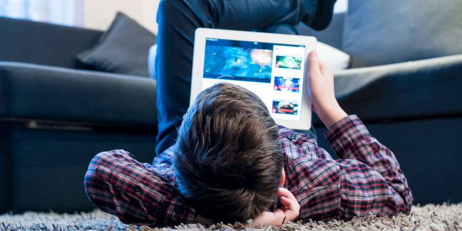 Enfant se connectant en ligne avec une tablette